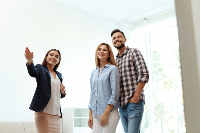 female housing specialist showing new house to couple